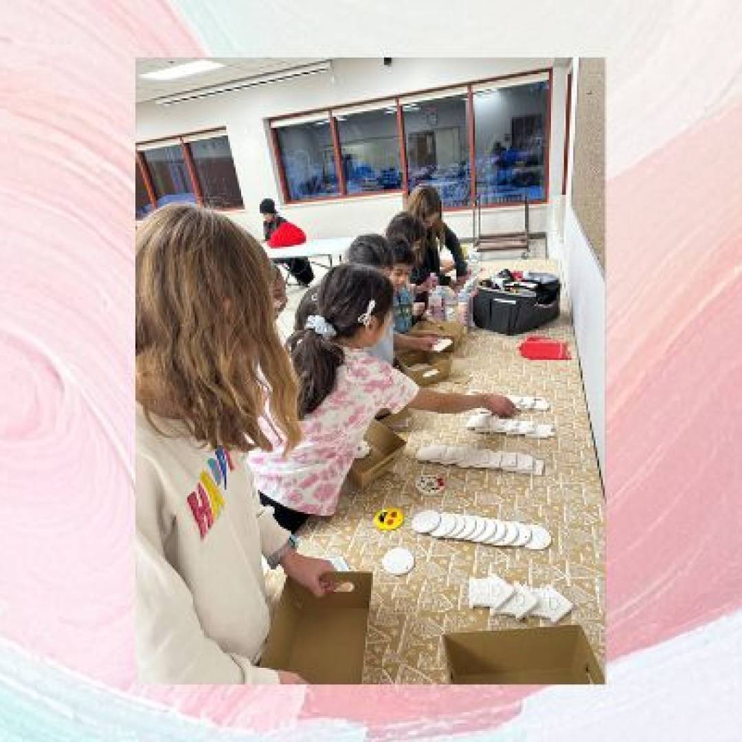 Children participating in a pottery painting class, decorating ceramic plates and crafts with paint and brushes.