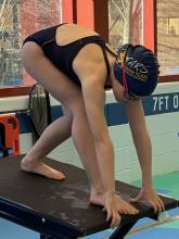 Swimmer on the block ready to race in the pool
